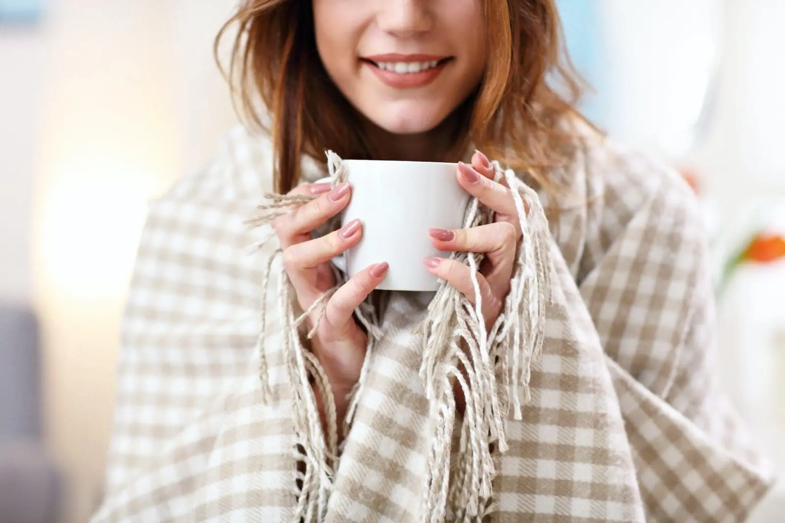 Adult woman covered with blanket having flu