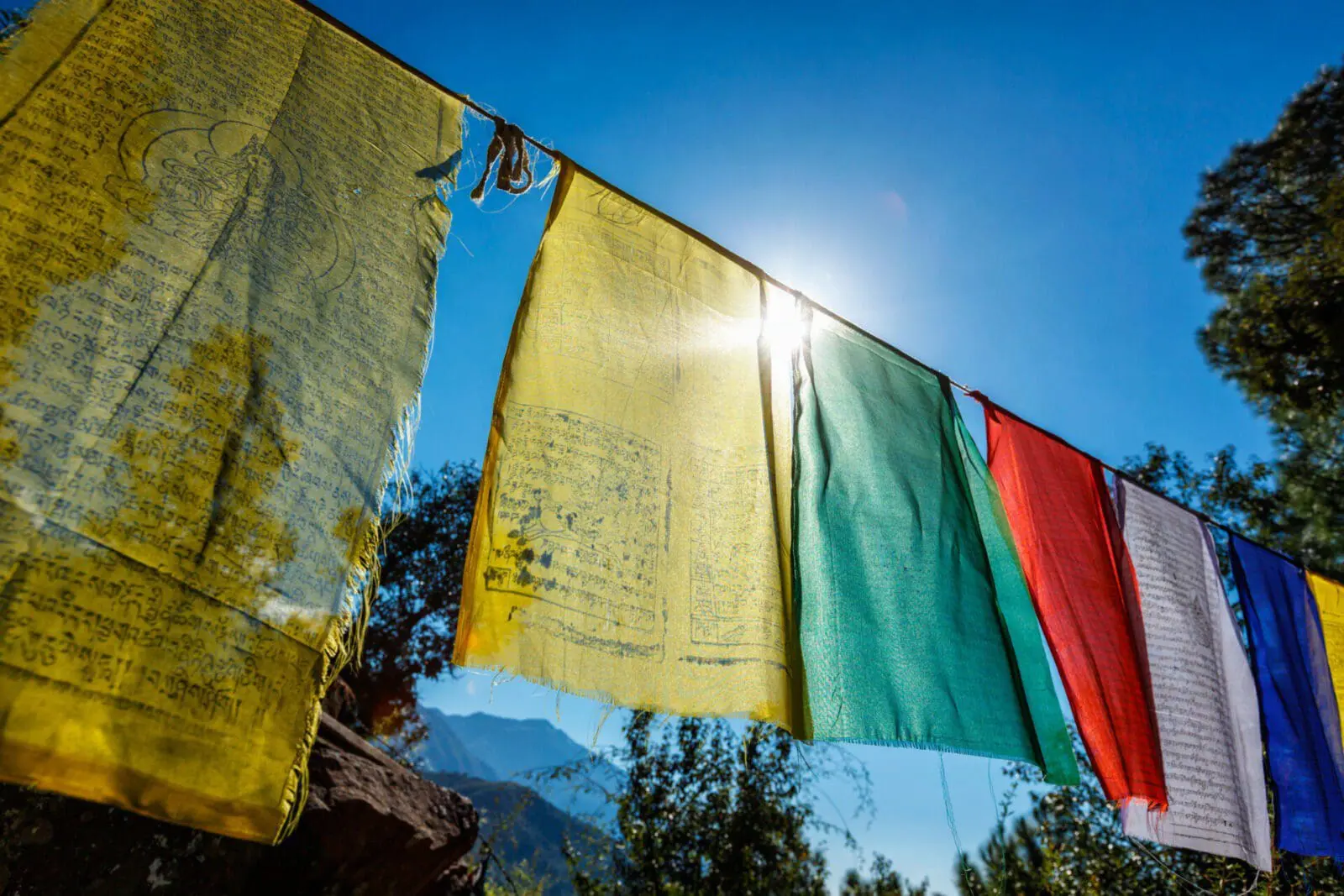 Prayer flags of Tibetan Buddhism with Buddhist mantra on it in Dharamshala monastery temple. India