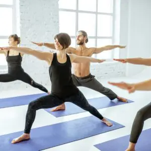 Group of people practising yoga indoors