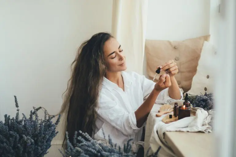 Woman applying natural organic essential oil on skin. Home spa beauty rituals.